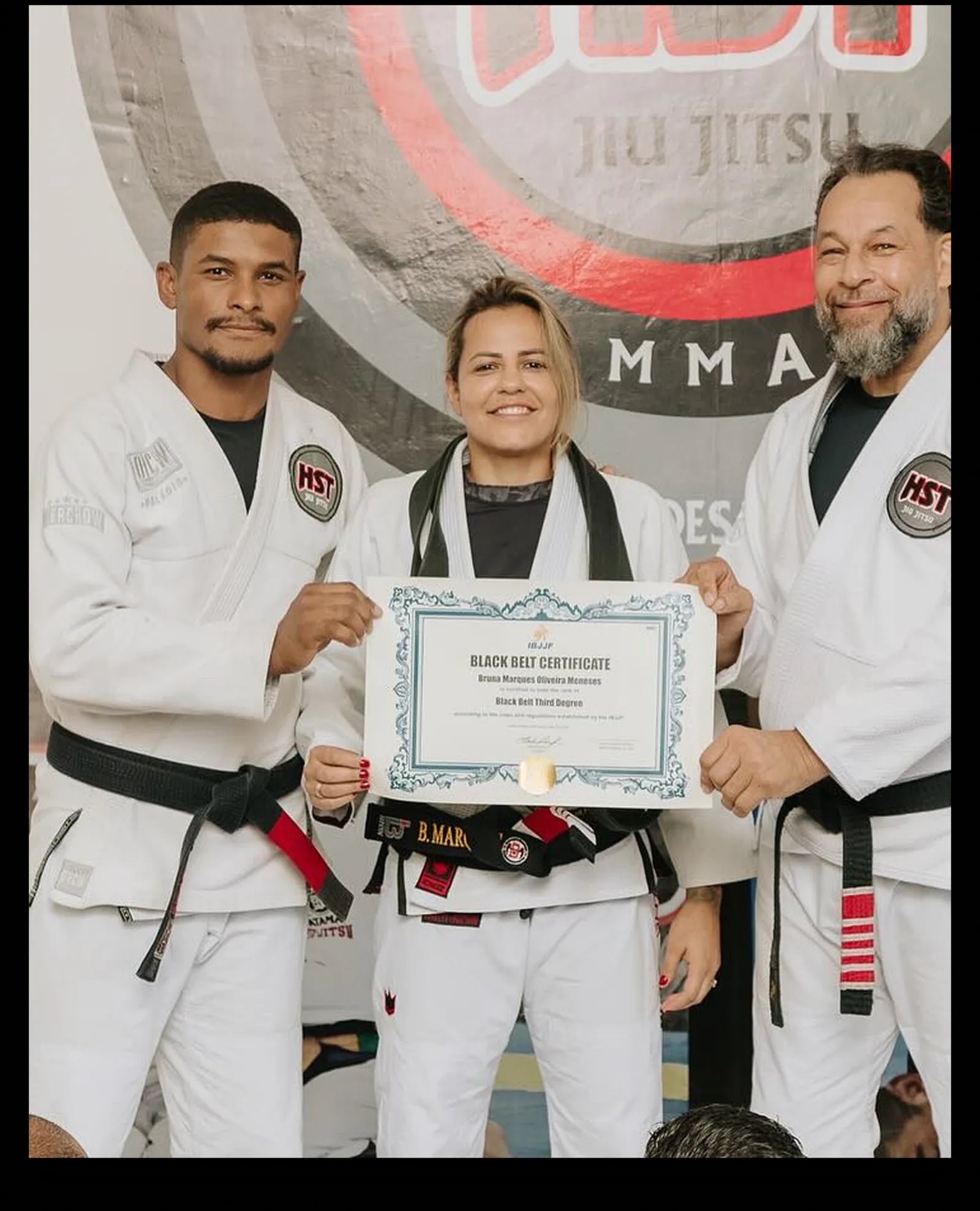 Bruna Marques receiving her third-degree black belt certificate